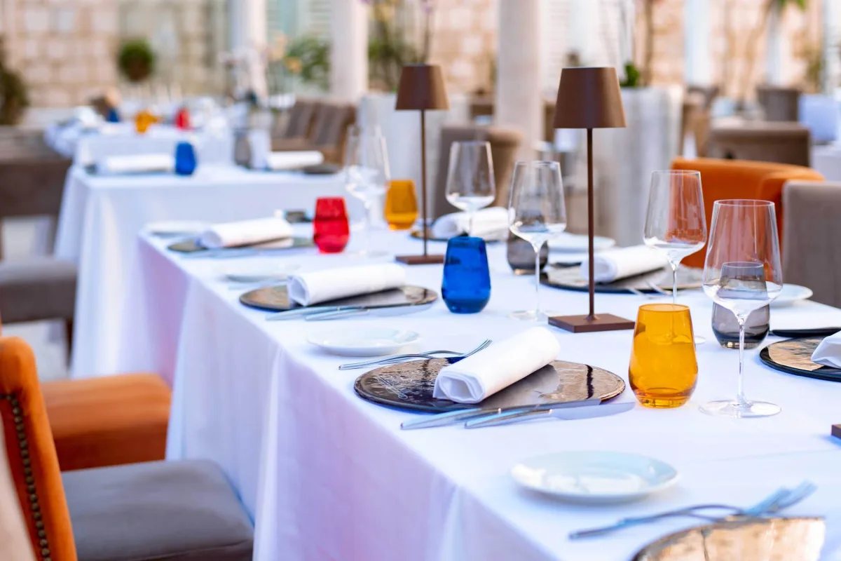 Restaurant Dubrovnik main terrace with chairs and plates - Restoran Dubrovnik
