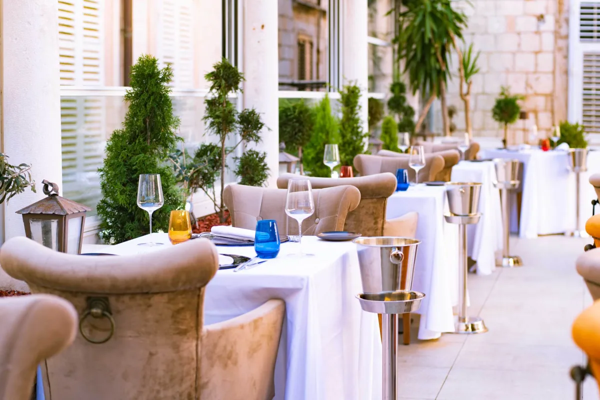 Restaurant Dubrovnik main terrace with chairs and plates and glasses - Restoran Dubrovnik