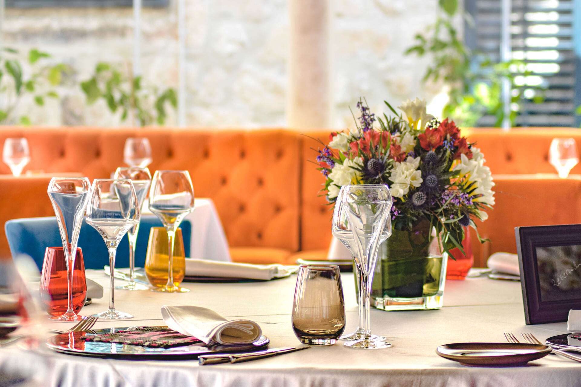 Restaurant Dubrovnik - table for guests with plates, custom made napkins with Restaurant Dubrovnik logo and wine glasses