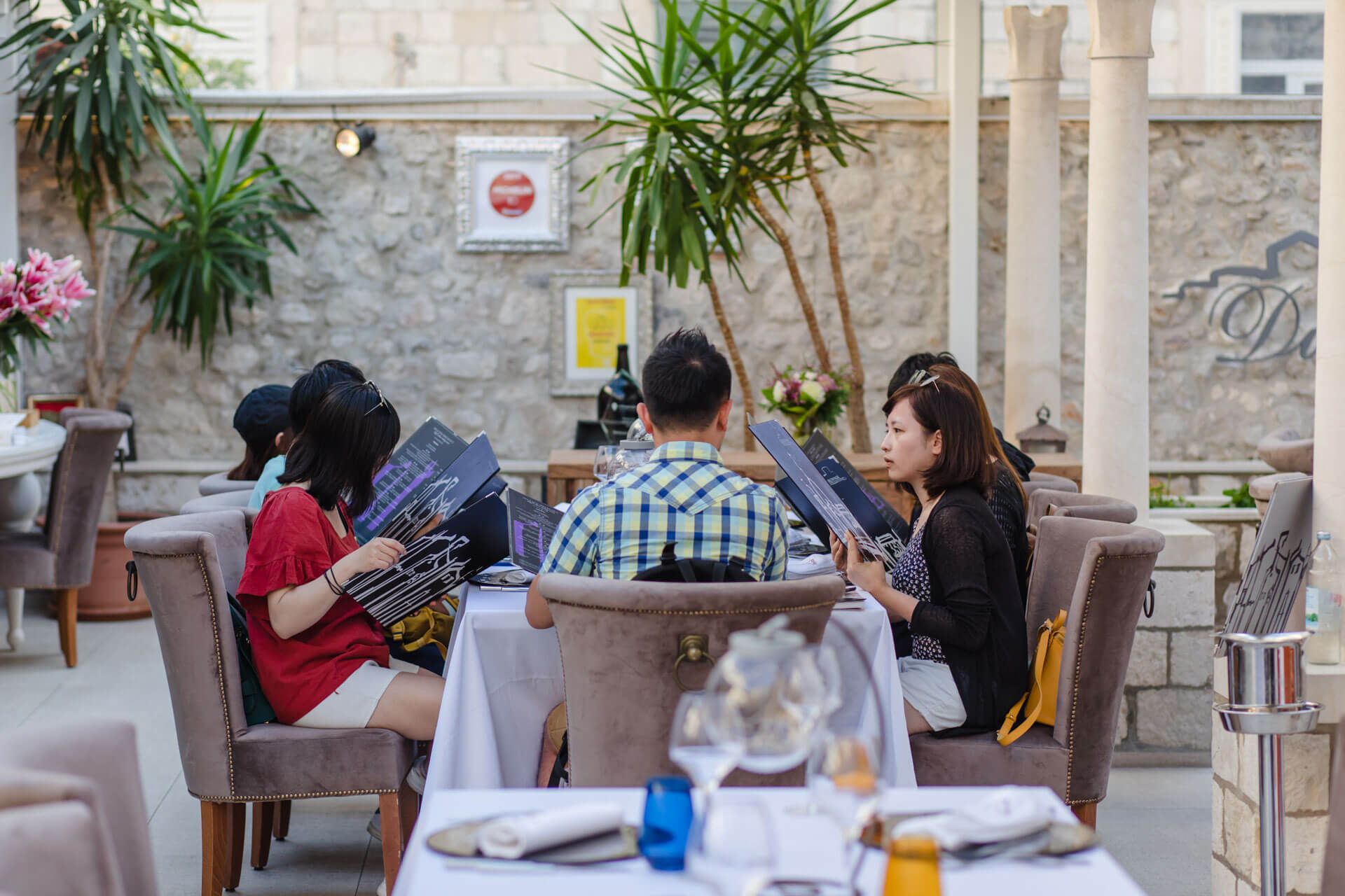 Restaurant Dubrovnik - guests sitting at table looking at custom made Restaurant Dubrovnik menus