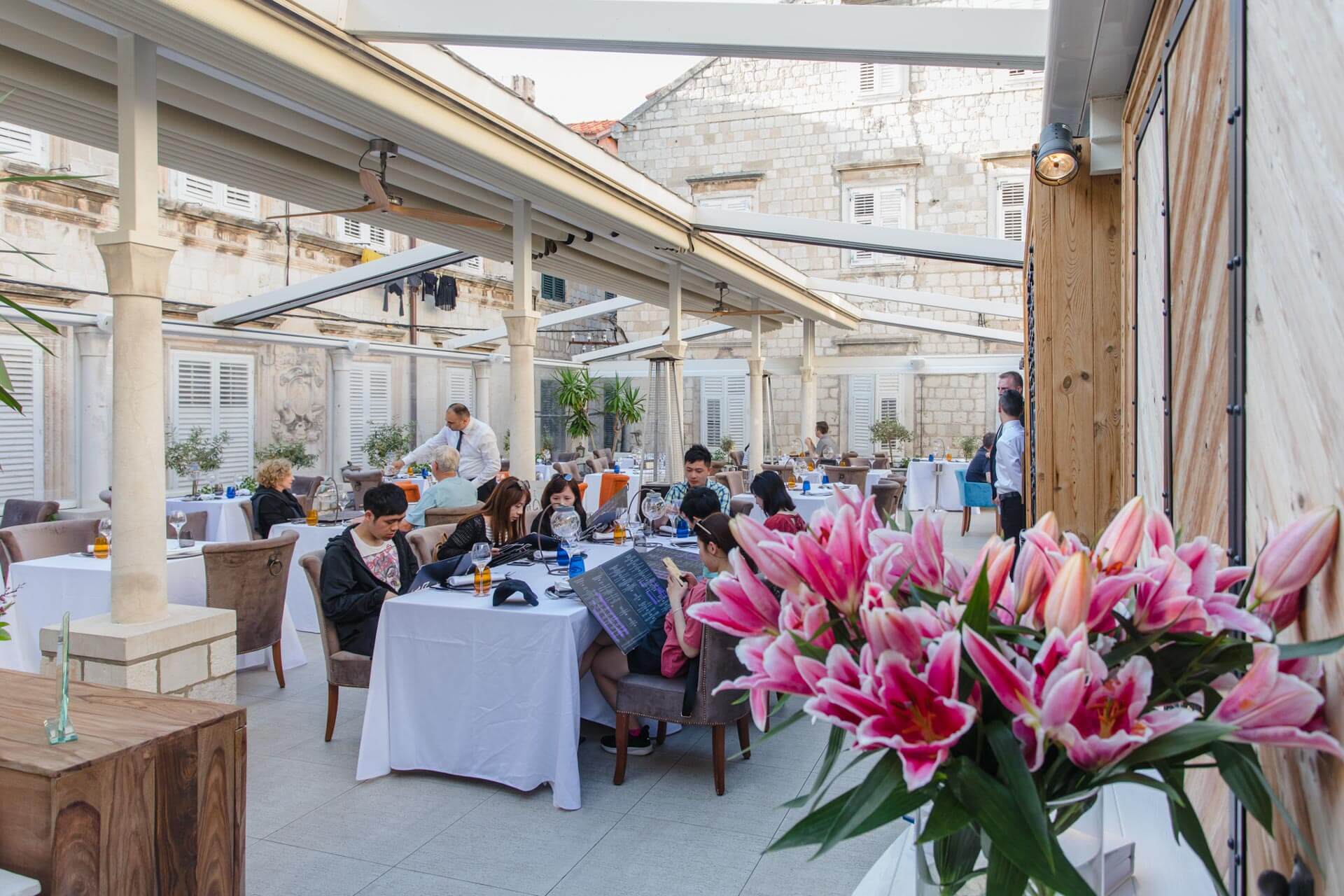 Restaurant Dubrovnik terrace full with guests waiting for their orders, talking and enjoying