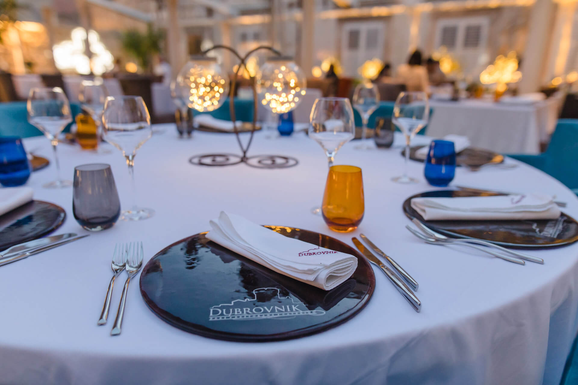 Restaurant Dubrovnik big table for eight people full with plates, custom made napkins and wine glasses