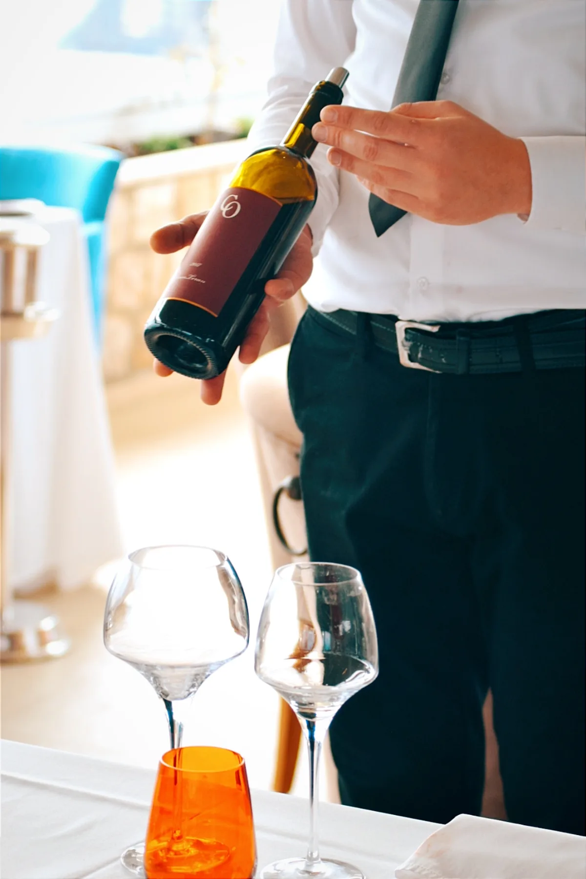 Restaurant Dubrovnik - waiter holding glass of red wine
